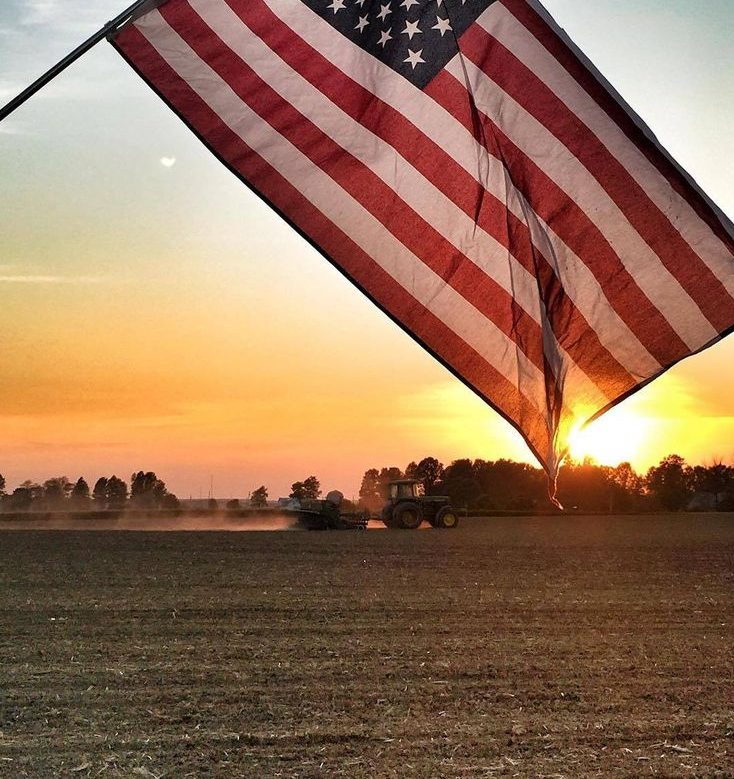 flag-with-tractor-in-background-e1753728739900
